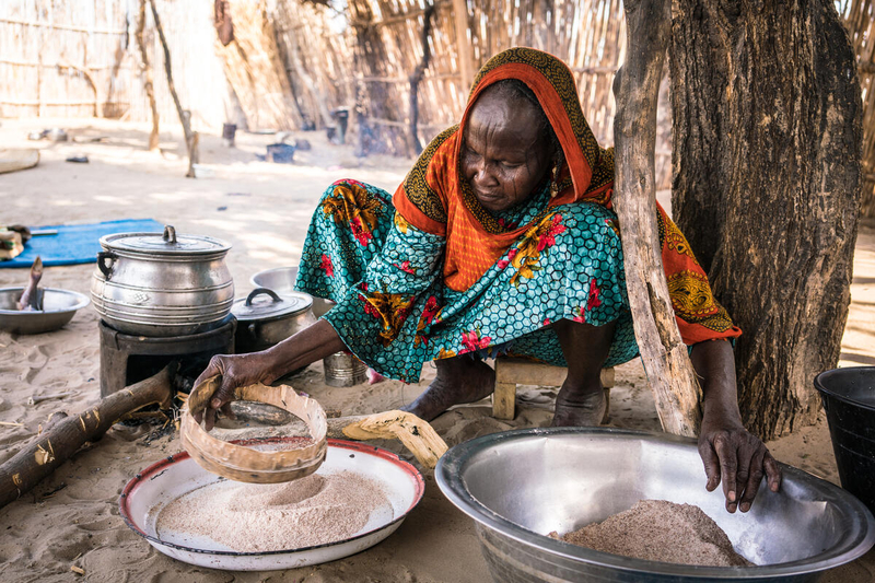 Photo: WFP/ Evelyn Fey Yakoua. Chad. Eine ältere Frau bereitet in ihrer Küche eine Mahlzeit zu