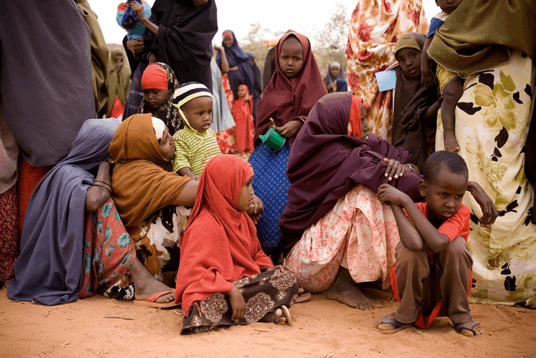 Women and children wait for assistance