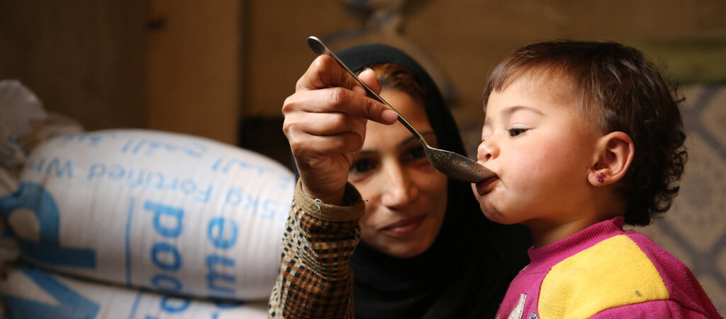 Syrische Mutter füttert Kind