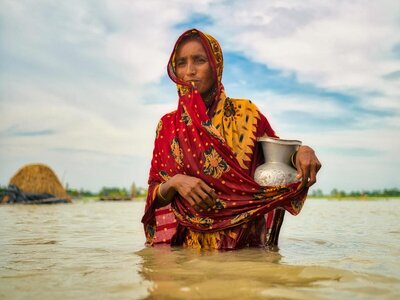 Woman walking in a flooded area