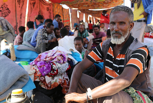 Refugees shelter from the hot sun