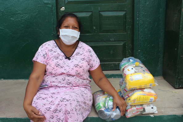Foto: WFP/Miller Choles, Diese Frau erhält WFP Nahrungsmittelrationen zum Mitnehmen für ihre Kinder, die an der Bildungseinrichtung Divina Pastora in Riohacha, La Guajira, Kolumbien, studieren.