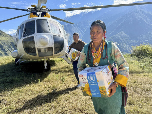 Foto: WFP/Tanya Birkbeck. Das WFP liefert per Hubschrauber Lebensmittel an die Bewohner des Dorfes Thuman im Bezirk Rasuwa in Nepal, nachdem Überflutungen die Straße zerstört hatten, die die Gemeinde mit den umliegenden Gebieten verband.