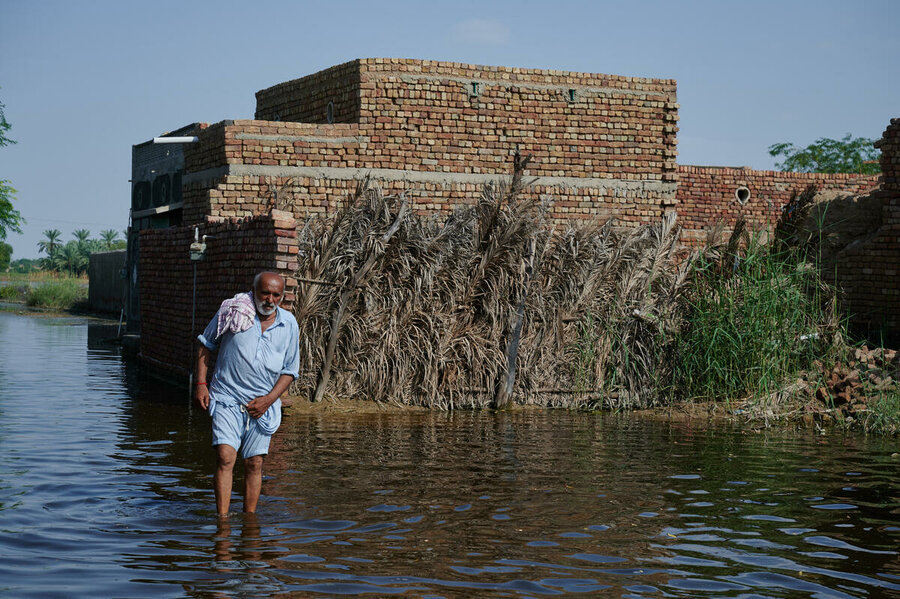 A man wades through Pakistan's floodwaters which submerged one-third of the country in 2022. Photo:WFP/Shehzad Noorani