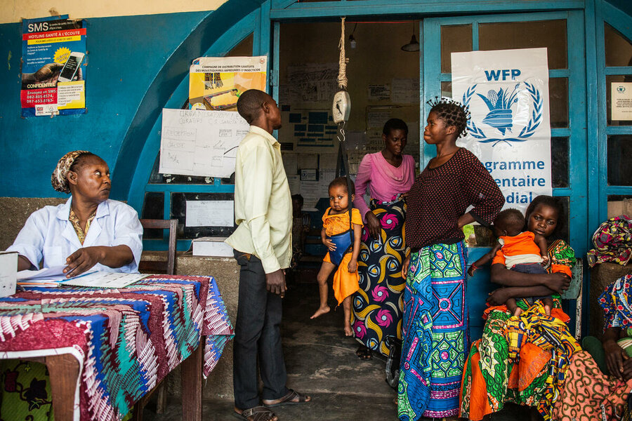 A health worker in Kasai Central province weighs three-year-old Mushawudi as part of a malnutrition screening. Photo: WFP/Vincent Tremeau