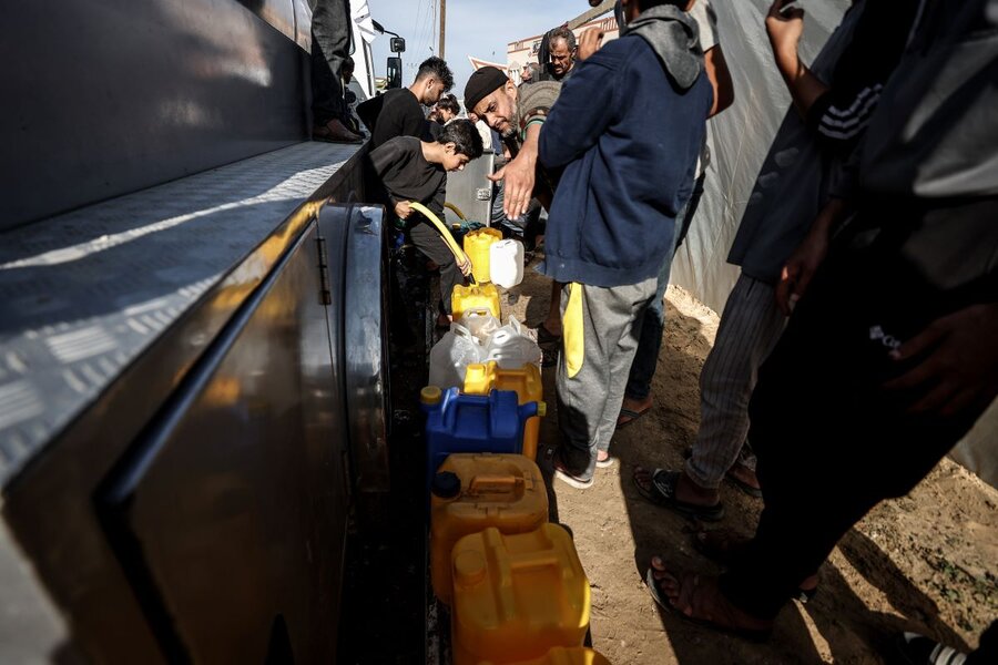 people queueing to fill up jerry cans with water in Gaza