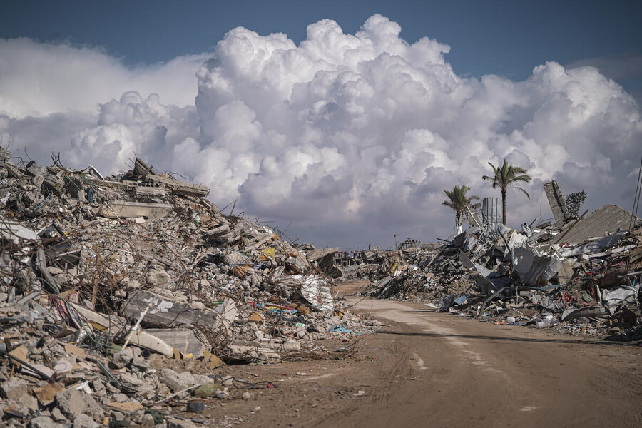 A road winds through rubble, leading toward billowing clouds that appear closer than they truly are