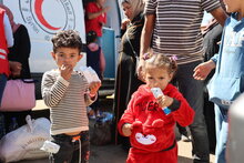 WFP/Hussam Al Saleh. thousands of Lebanese and Syrians flee into war-torn Syria. WFP is providing fortified date bars for the children as the entry procedures are taking long time approximately 2 hours minimum due to the huge numbers arriving at the border.